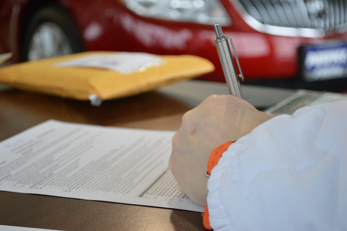 A New Zealand car owner reviewing paperwork.