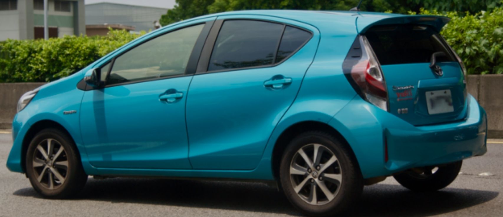 Light blue Toyota Aqua parked on a New Zealand street, representing the country's most stolen car and its significant impact on comprehensive car insurance premiums in the 2026 Quashed vehicle insurance guide.