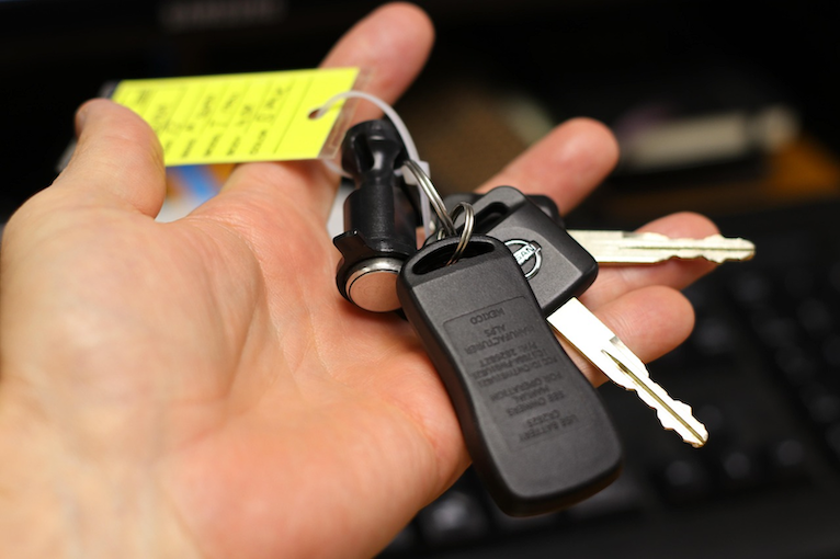 Person holding car keys for a new vehicle.