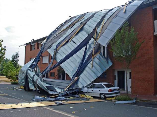 A residential building and car damaged by a severe weather event, highlighting the importance of Vero's AA- financial strength rating for claims in 2026.