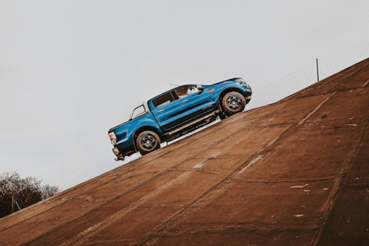 A blue Ford Ranger parked on a steep concrete incline, representing New Zealand's most popular ute which carries high average insurance premiums and large quote spreads on Quashed in 2026.
