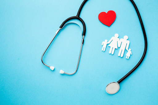 A black stethoscope, a red heart, and a paper cutout of a family on a blue background, representing 2026 Southern Cross family health cover featured by Quashed.