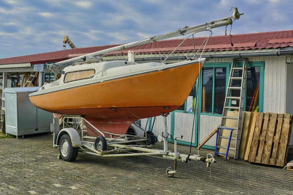 Orange sailboat on a trailer at a boatyard, illustrating Tower Insurance cover options for boats, cars, and property — image used in a Quashed Tower Insurance review.