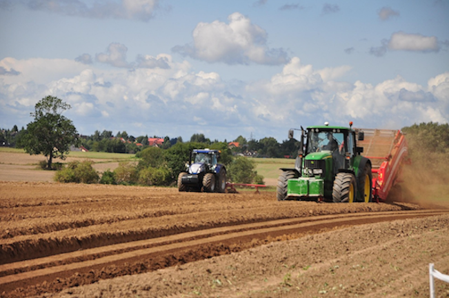 Two tractors working a field in rural New Zealand, illustrating FMG’s 120-year history as a specialist rural and farm insurer in this 2026 Quashed review.