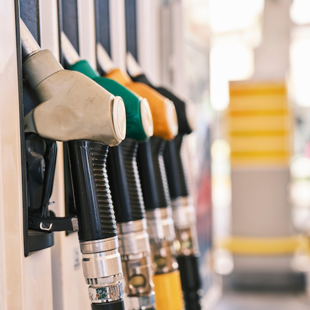 A selection of different coloured fuel pump nozzles (91, 95, and 98 octane) at a New Zealand service station, representing the importance of choosing the correct fuel type to maximise efficiency and save money during the 2026 petrol crisis.