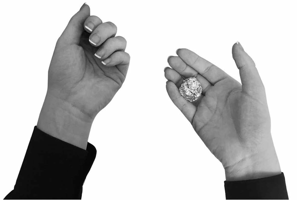 Woman's hands with tinfoil ball in right hand