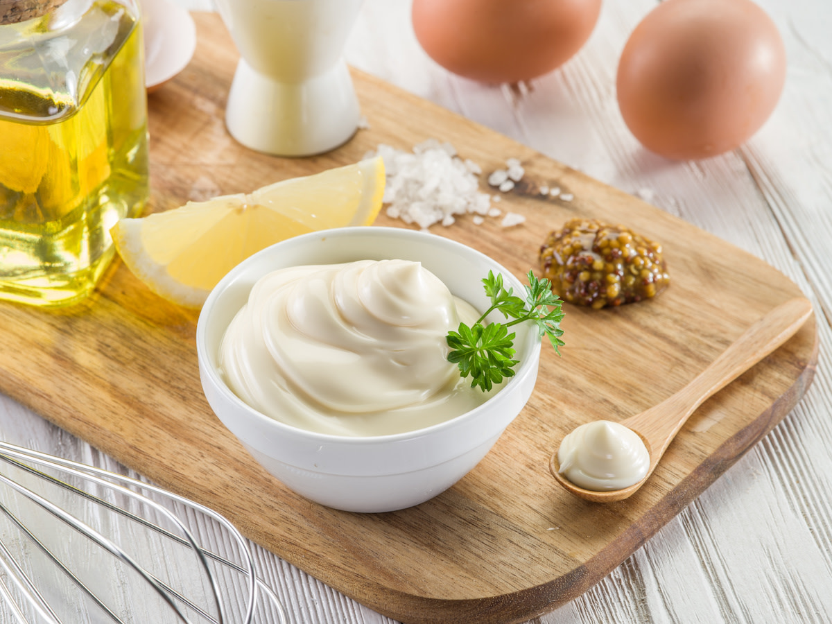 mayonnaise in small bowl with mustard, lemon and eggs