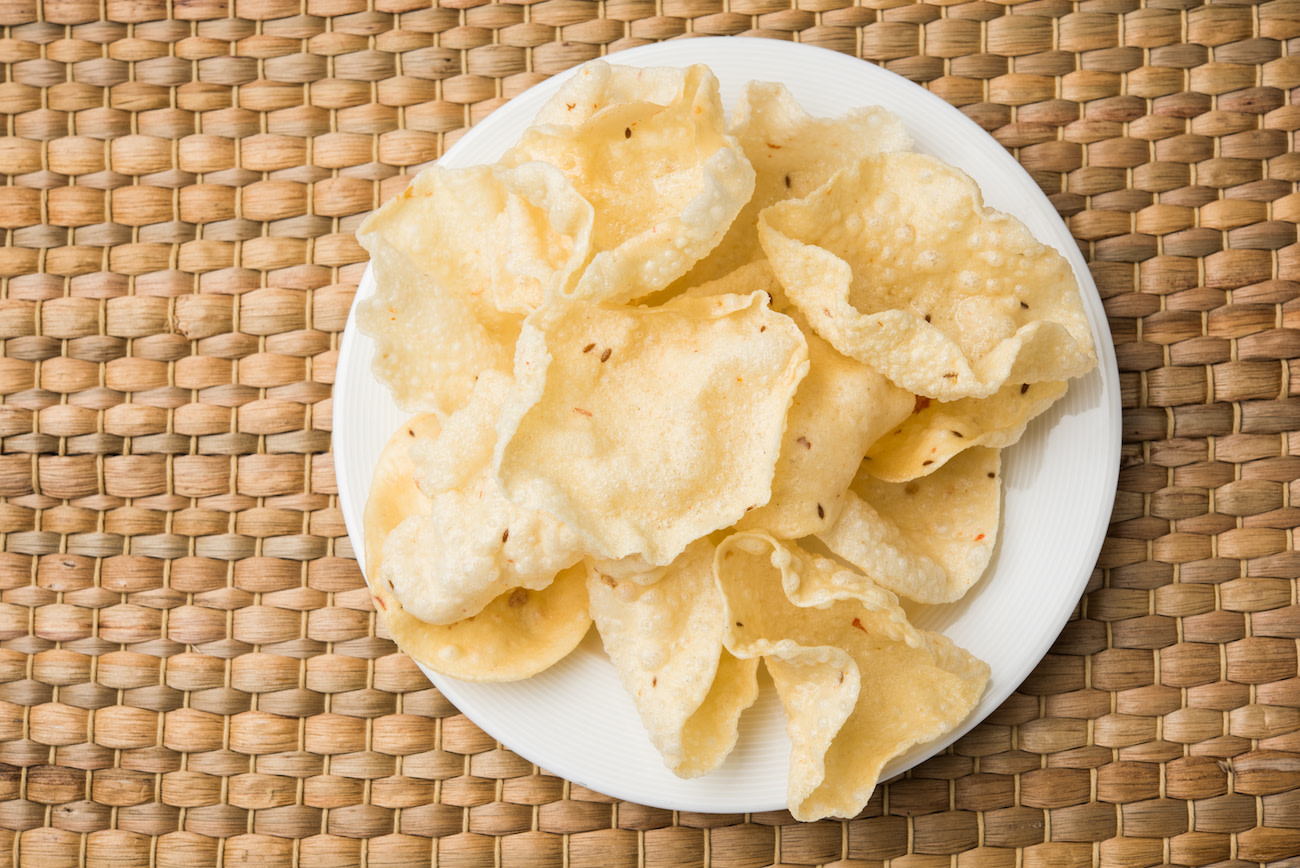 papadam crackers on plate with woven background