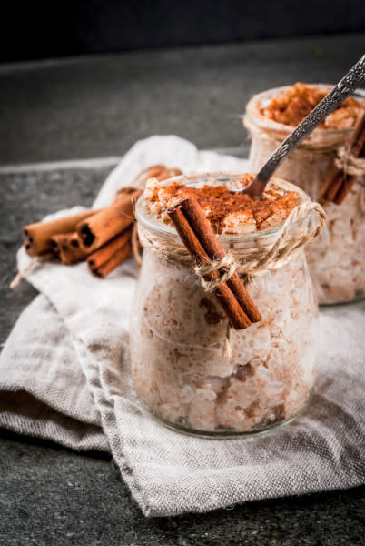 Arroz con Leche in a jar with cinnamon sticks