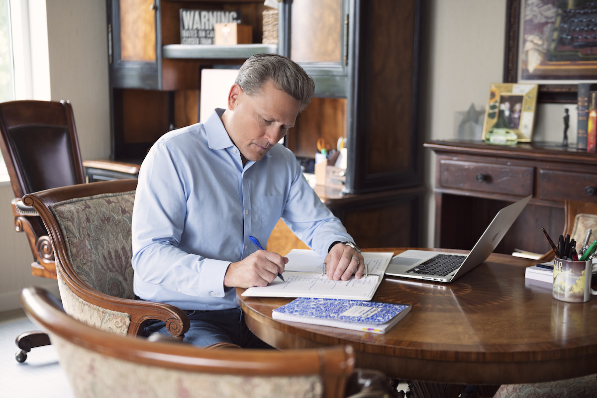 David Baldacci writing at desk