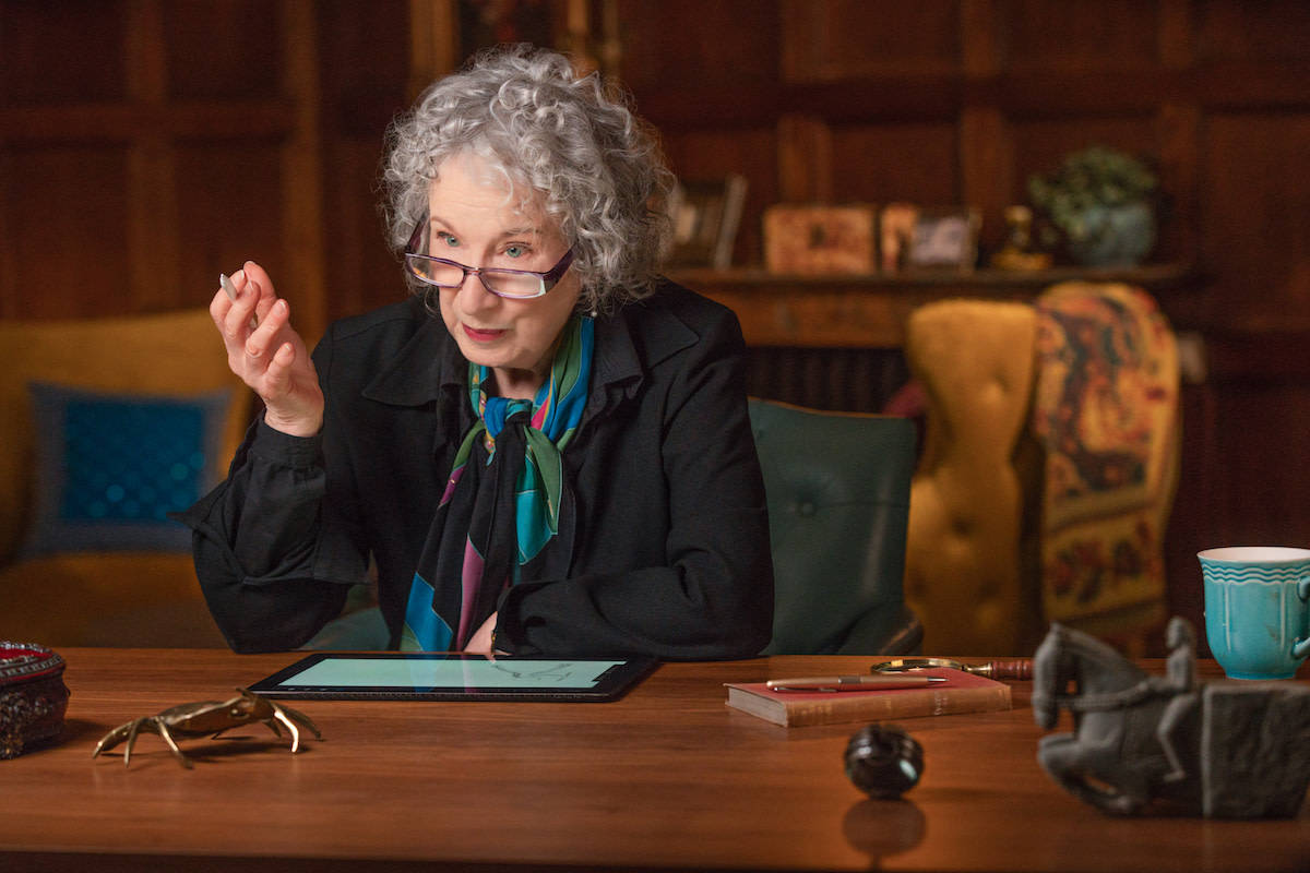 Margaret Atwood at desk explaining something