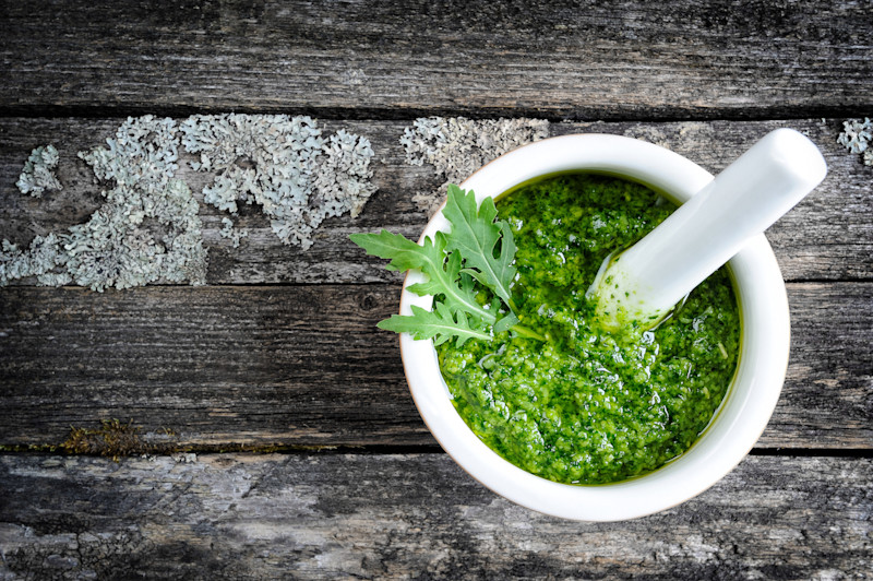 Fresh basil pesto in a mortar and pestle