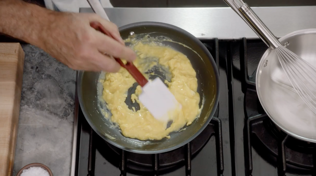 Scrambled eggs on pan with spatula