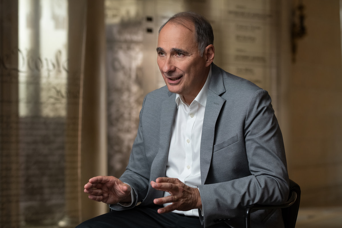 David Axelrod in chair with hands up