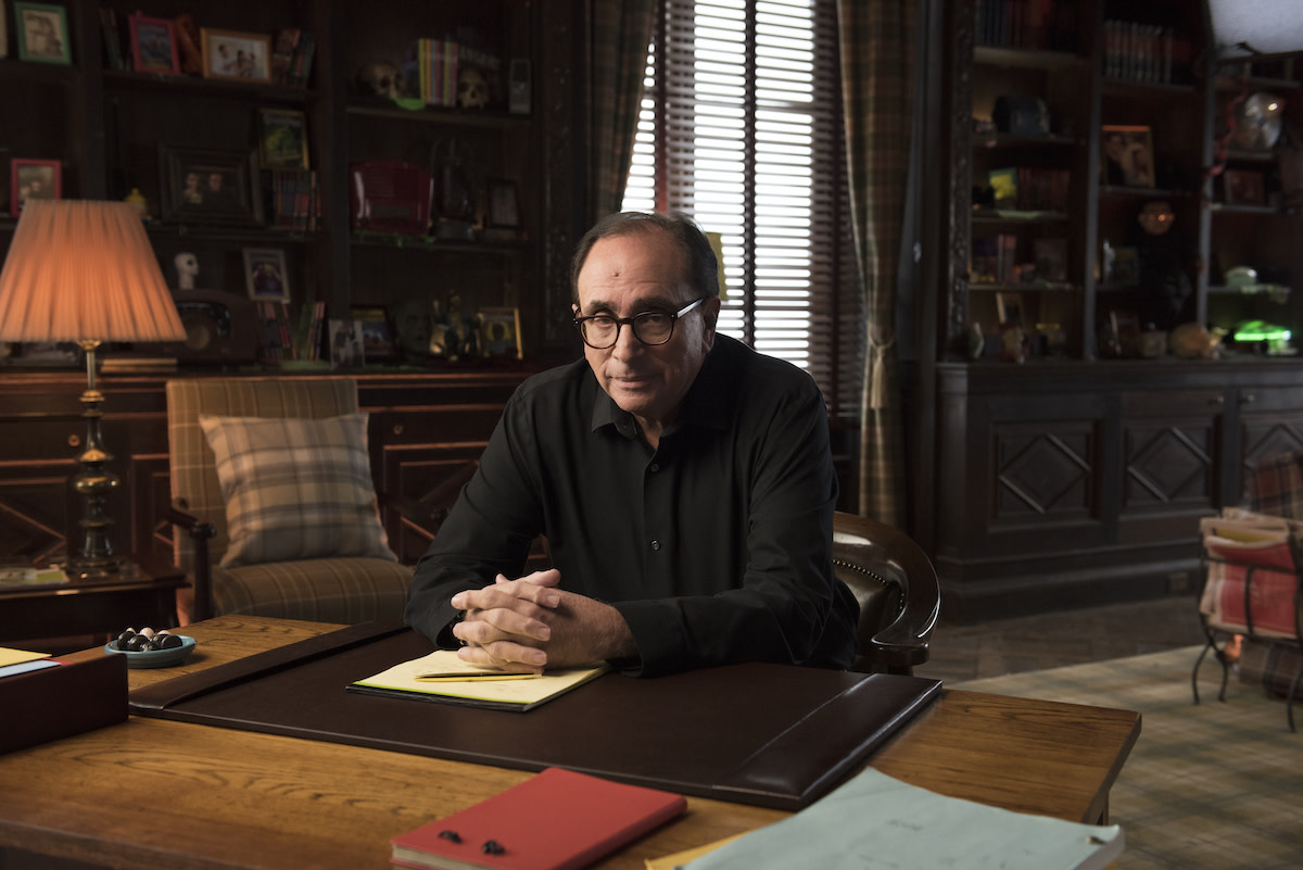 R.L. Stine in library desk with hands crossed