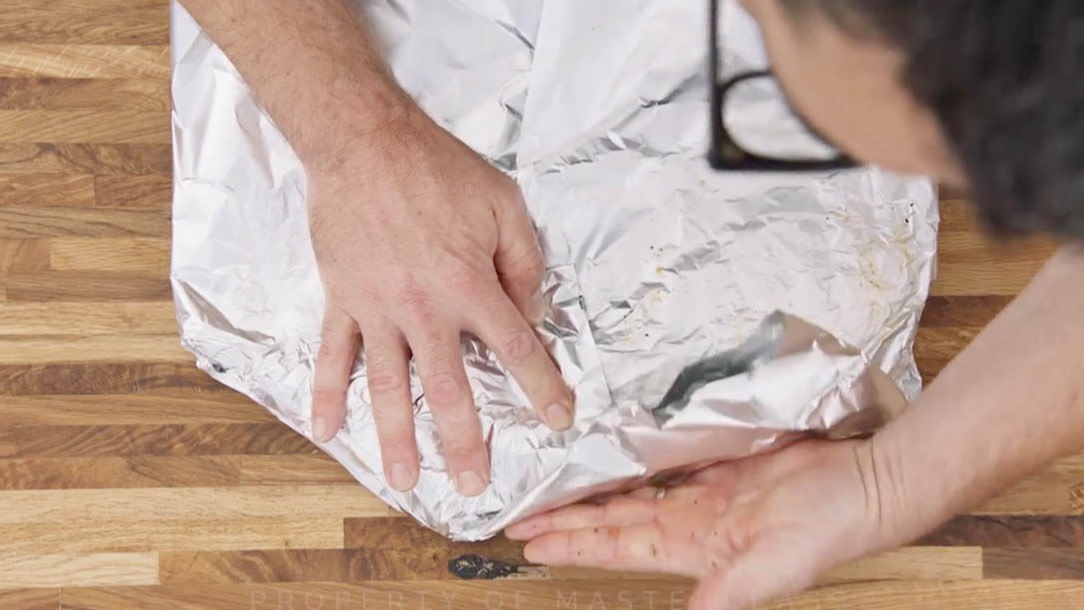 Aaron Franklin wrapping ribs in tinfoil step 4