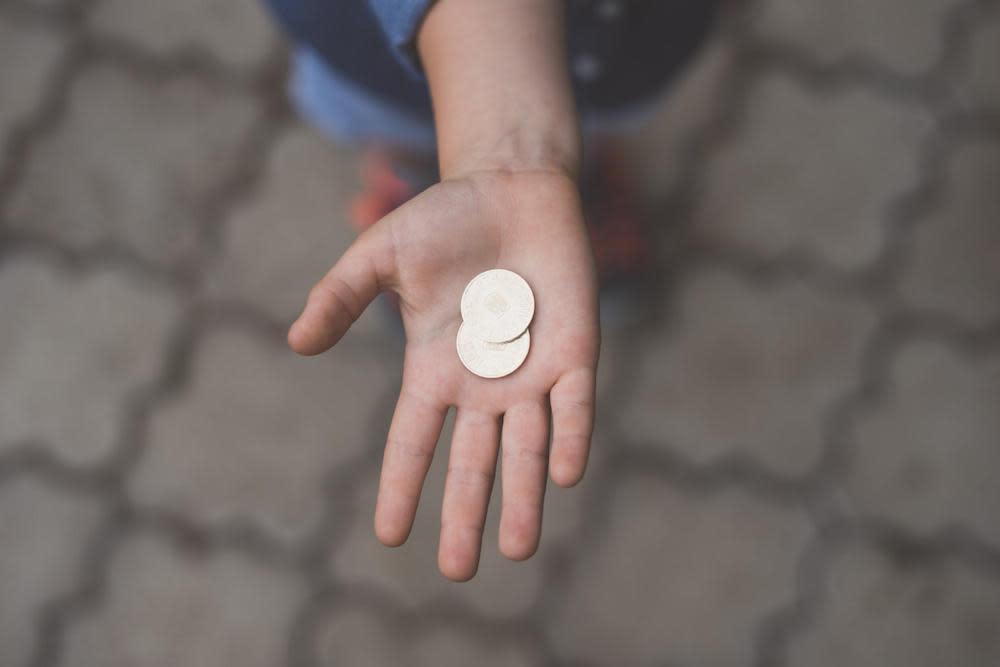 coins in a persons hand