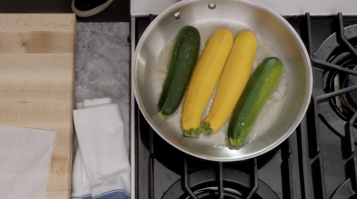 Zucchini on pan with oil