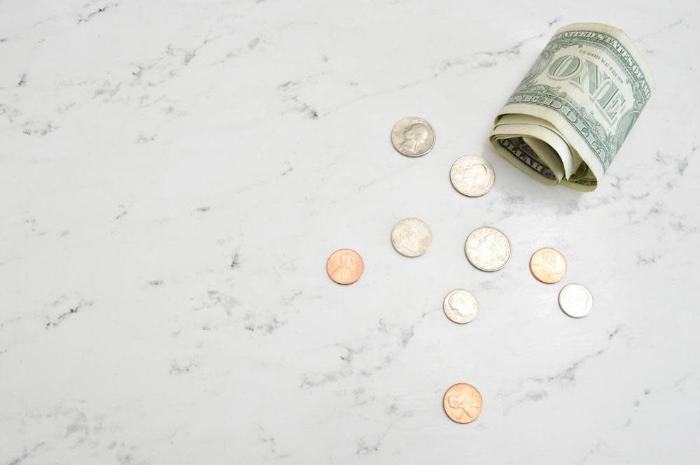 Coins and a dollar bill on a table