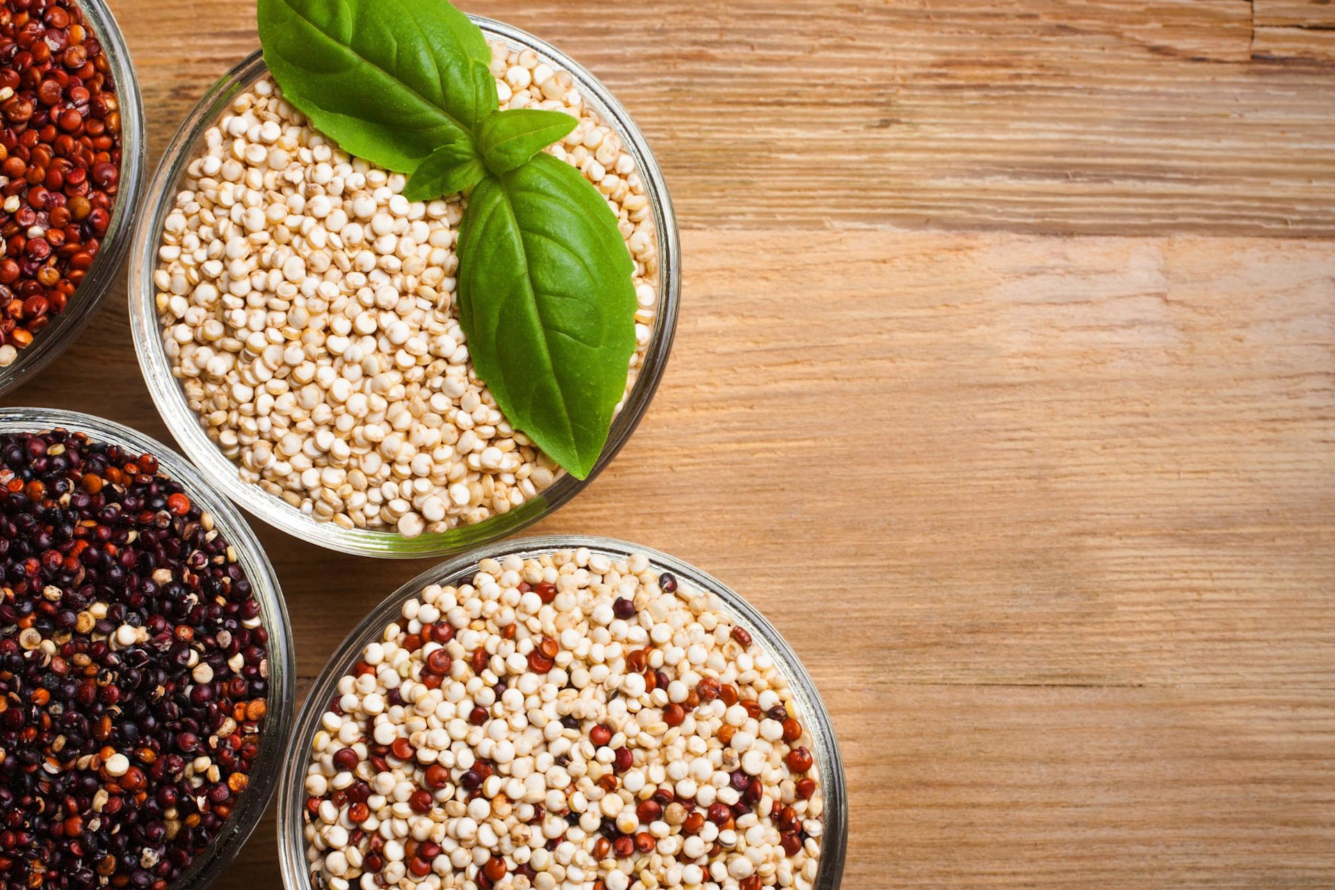 cups of different colored quinoa