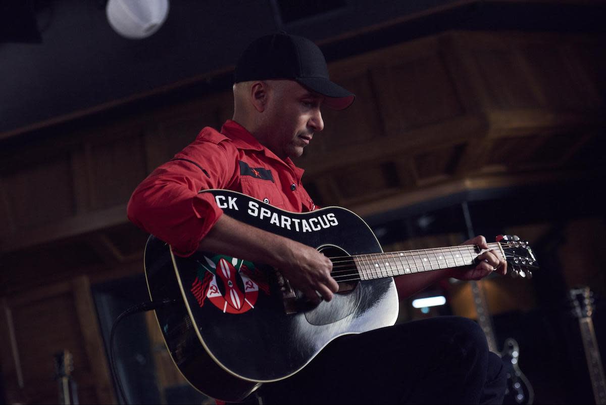 tom morello playing his acoustic guitar