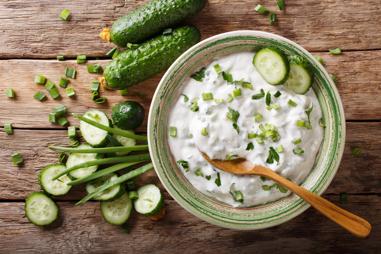 raita yogurt sauce with pickles on wood