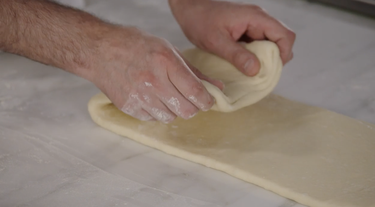 Dominique Ansel folding croissant dough