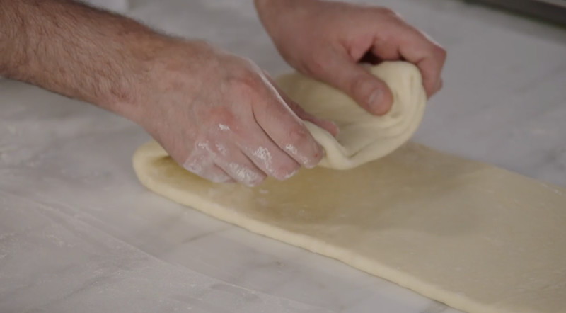 Dominique Ansel folding croissant dough