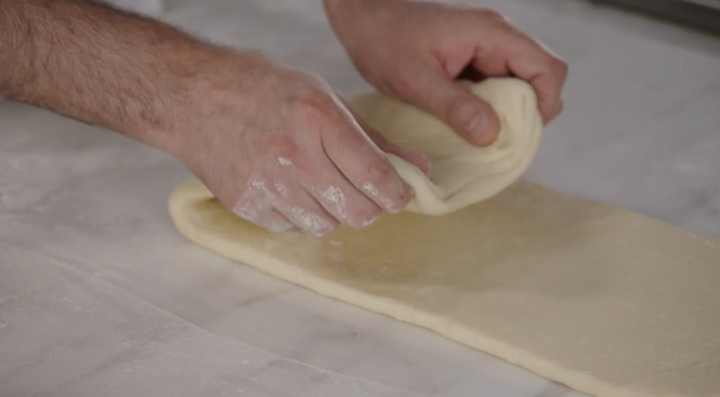 Dominique Ansel folding croissant dough