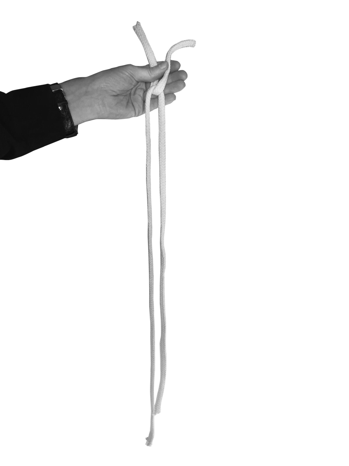 Person holding connected folded rope pieces 