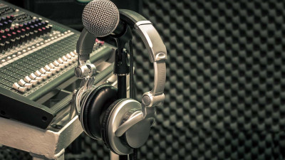 Microphone and headphones in recording studio