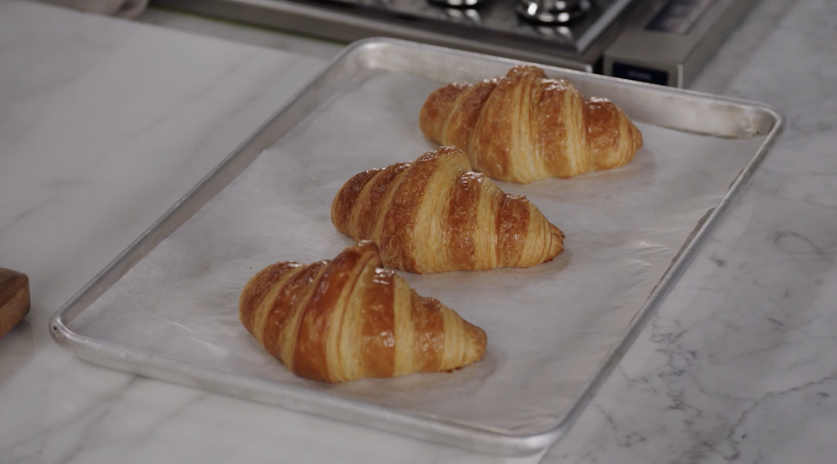 Baked croissants on baking tray