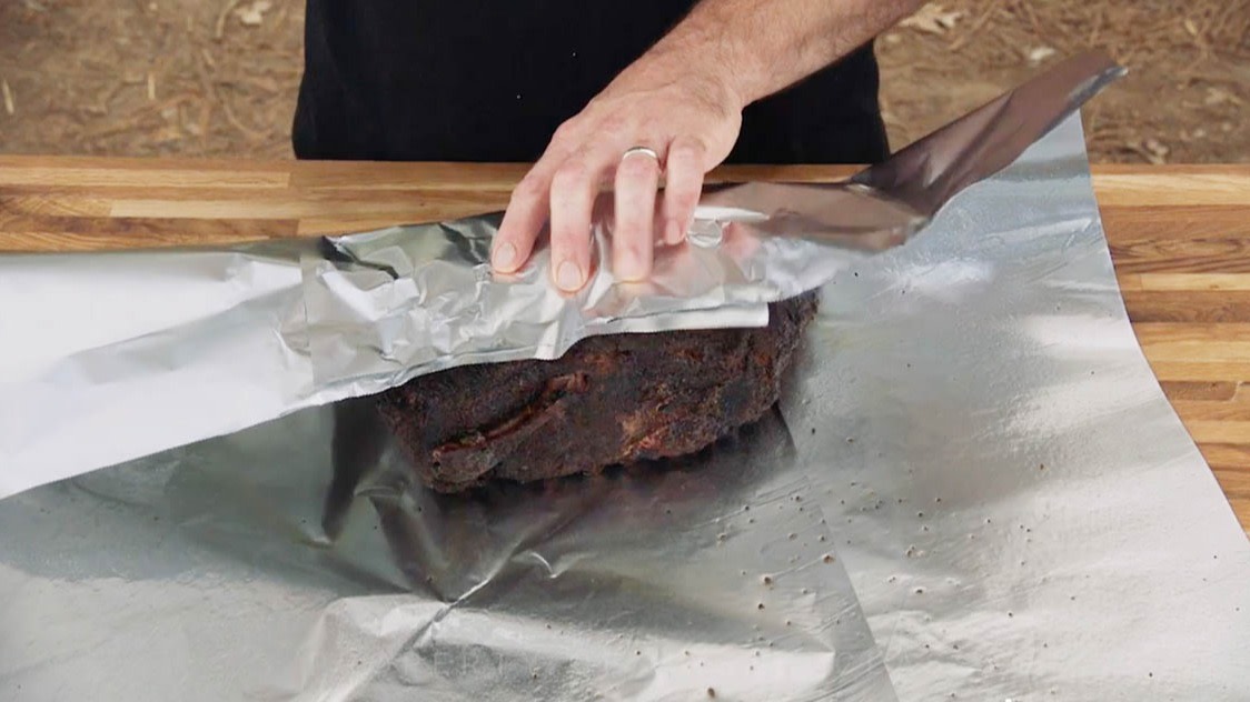 Aaron Franklin wrapping meat in tinfoil