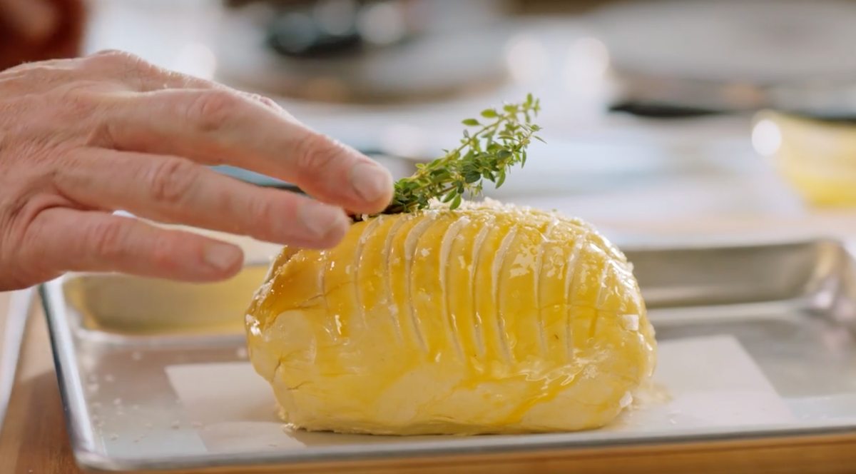 Gordon Ramsay putting herbs on Beef Wellington