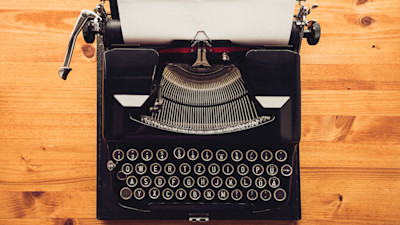 Typewriter with paper on wood