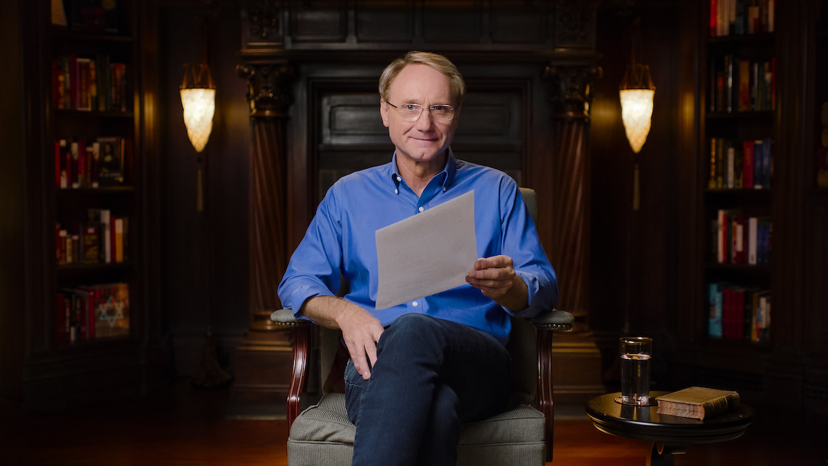 Dan Brown with paper in chair