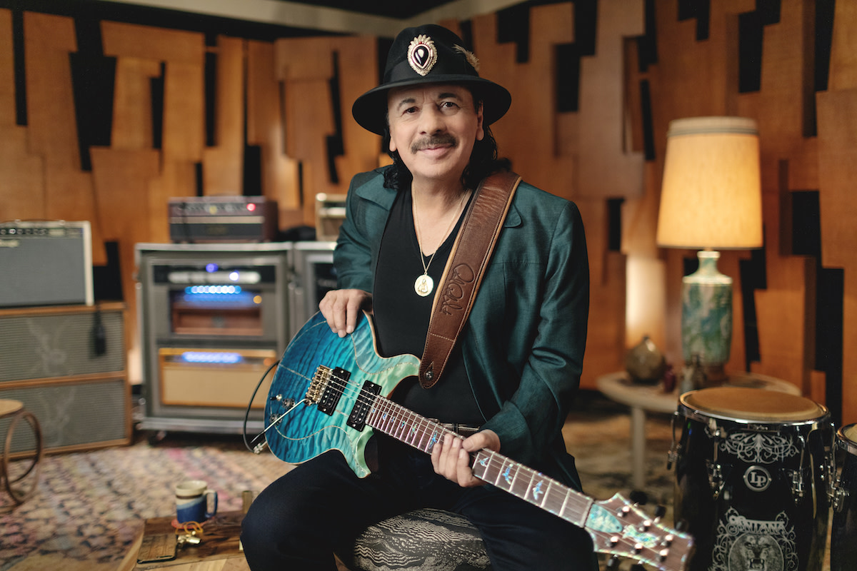 Carlos Santana with blue electric guitar in studio