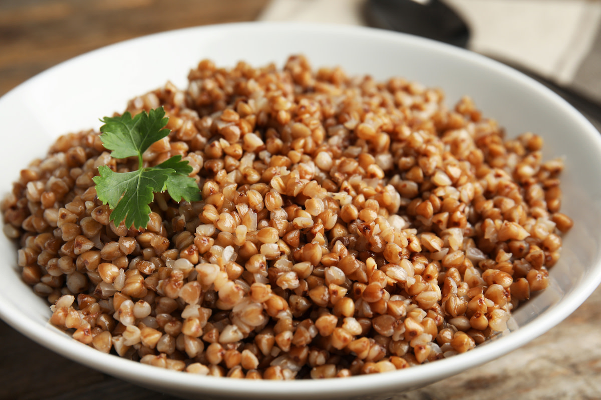 Cooked buckwheat in bowl with garnish