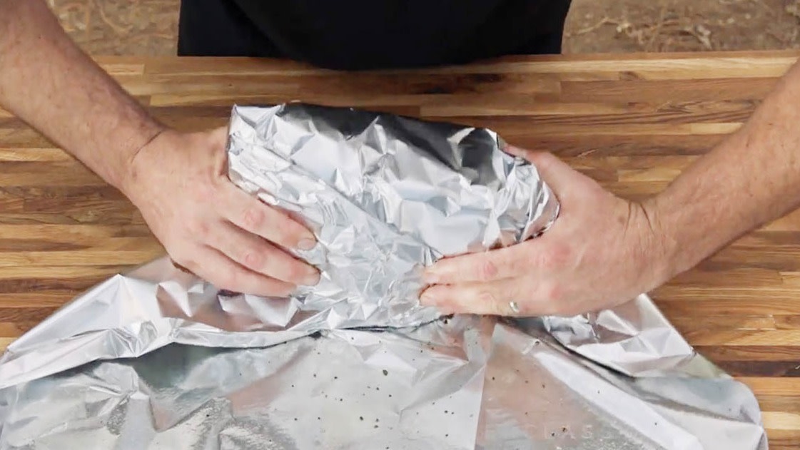 Aaron Franklin wrapping meat in tinfoil