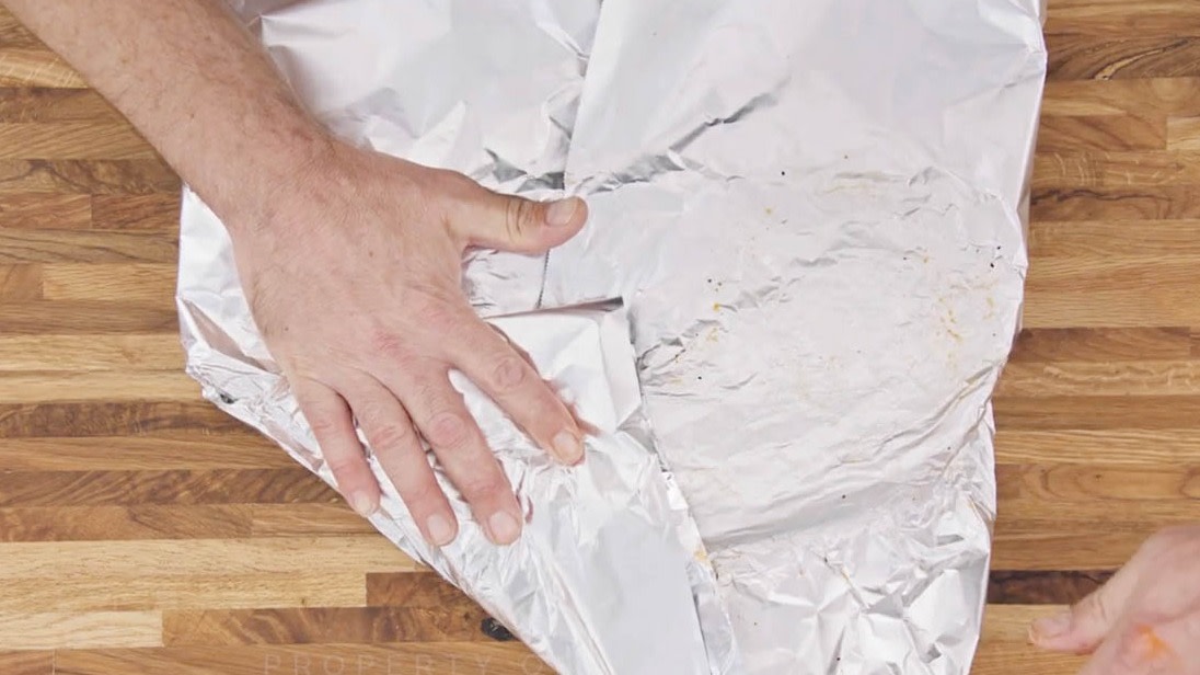 Aaron Franklin wrapping ribs with tinfoil step 3