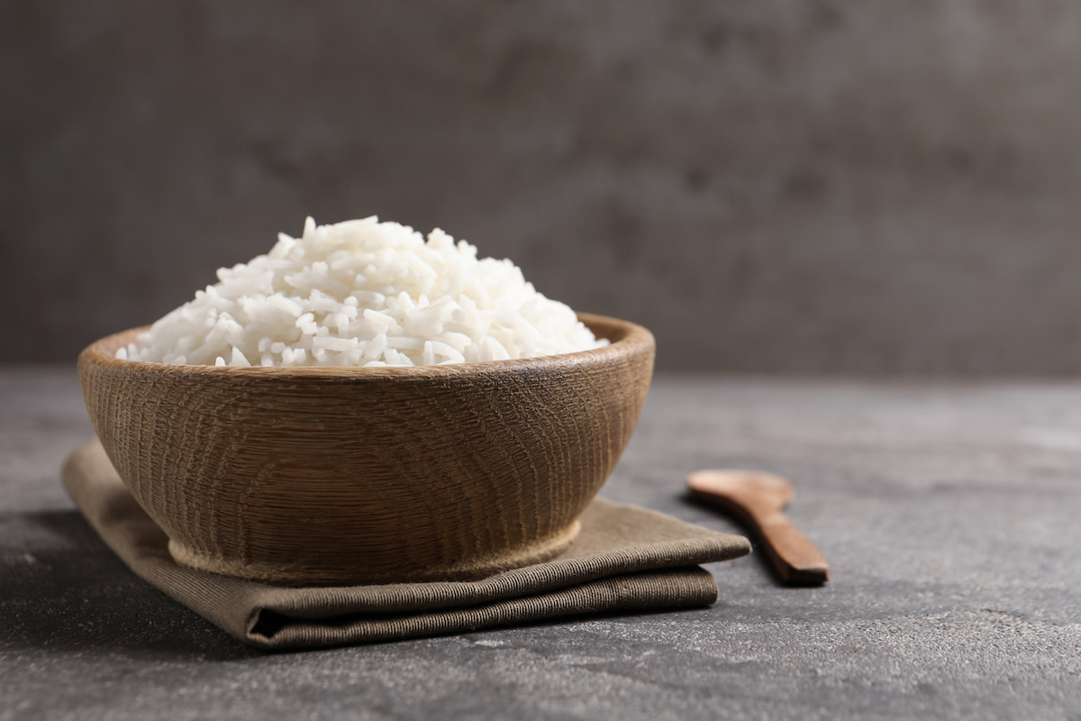 Cooked white rice in wooden bowl