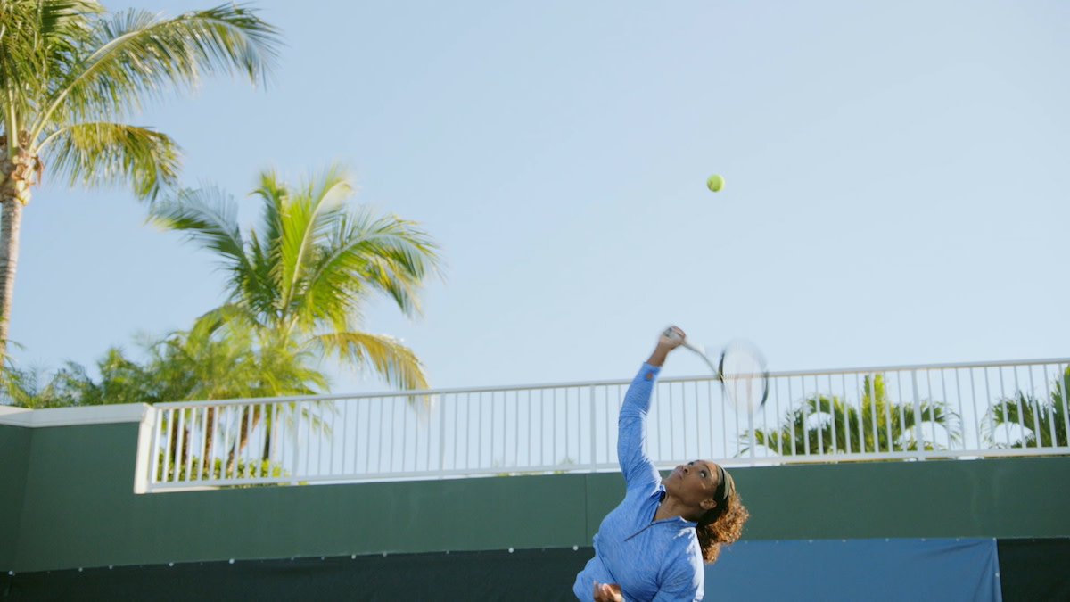 Serena Williams hitting tennis ball with racquet