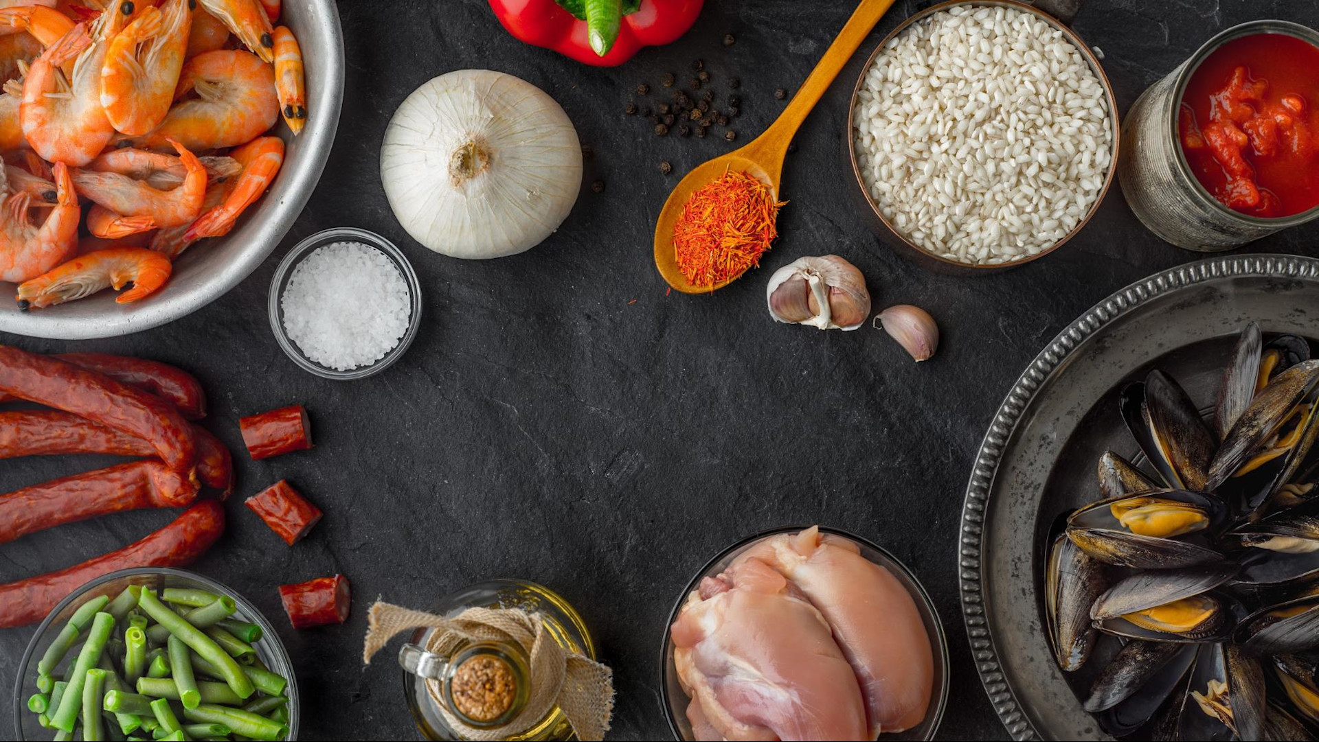 Ingredients for paella on black table