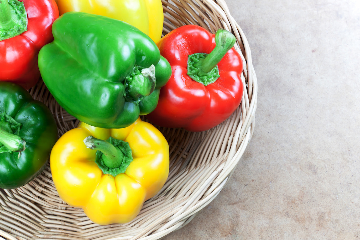 Red, yellow, and green bell peppers in basket