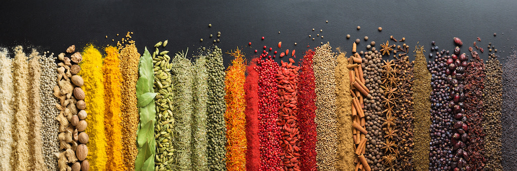 A table filled with colorful Indian Spices