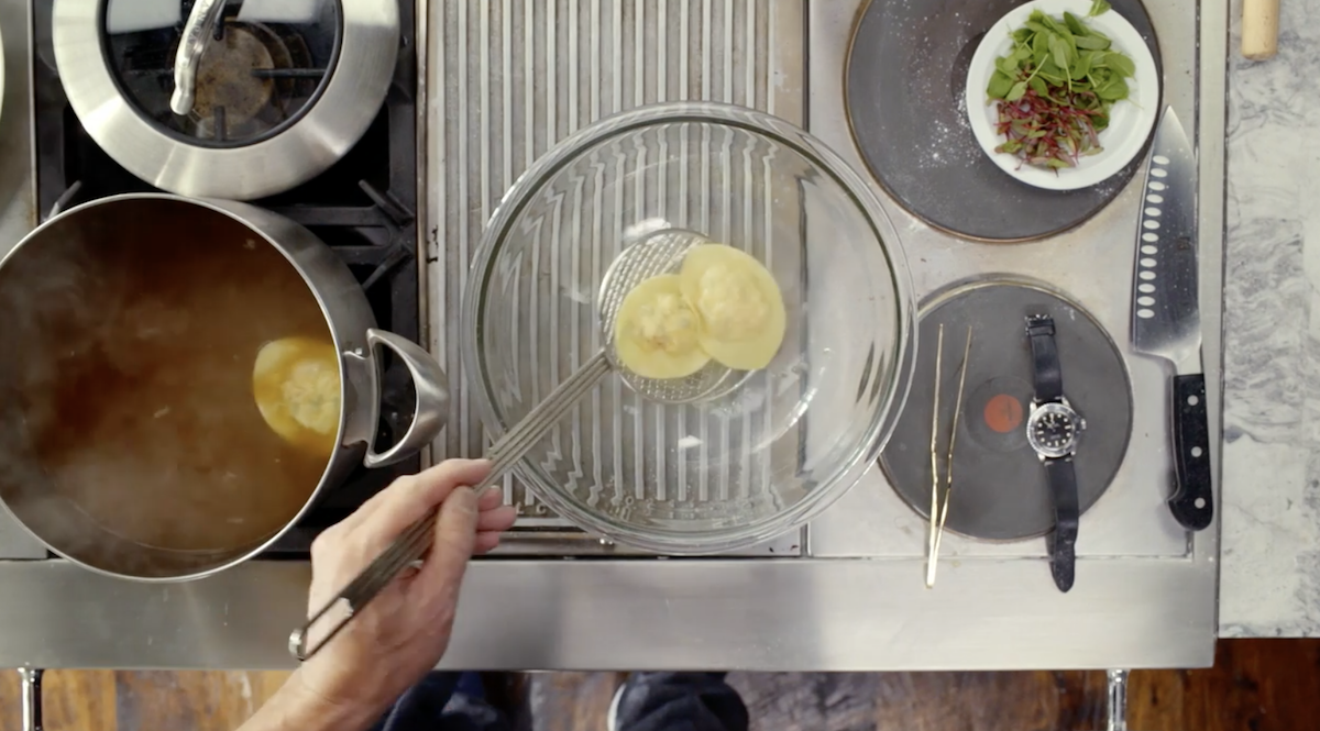 Gordon Ramsay placing raviolis into glass bowl