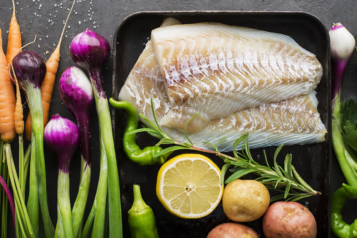 Halibut on tray with raw ingredients