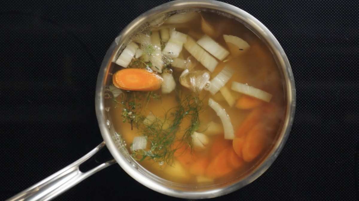 Vegetables in broth in pot