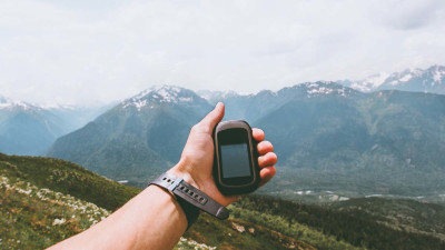 man holding gps in the mountains