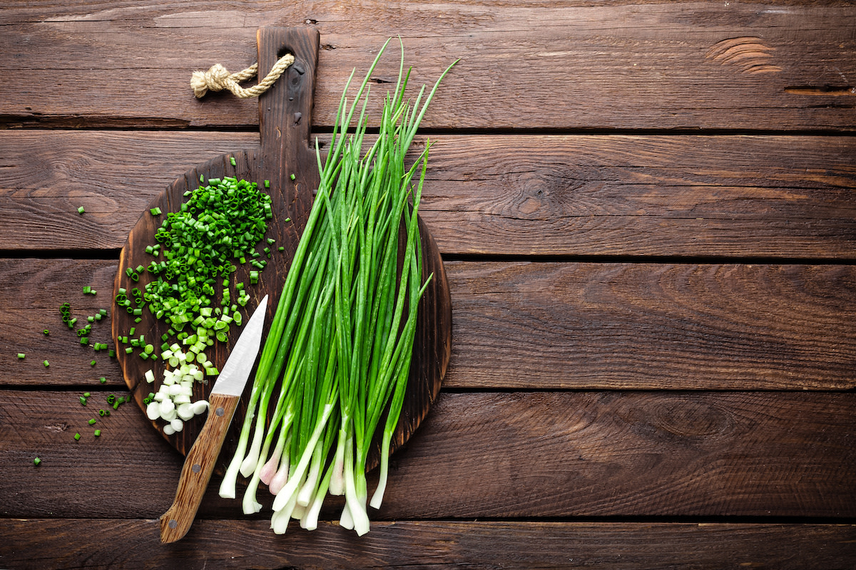 chopped green onions on wood